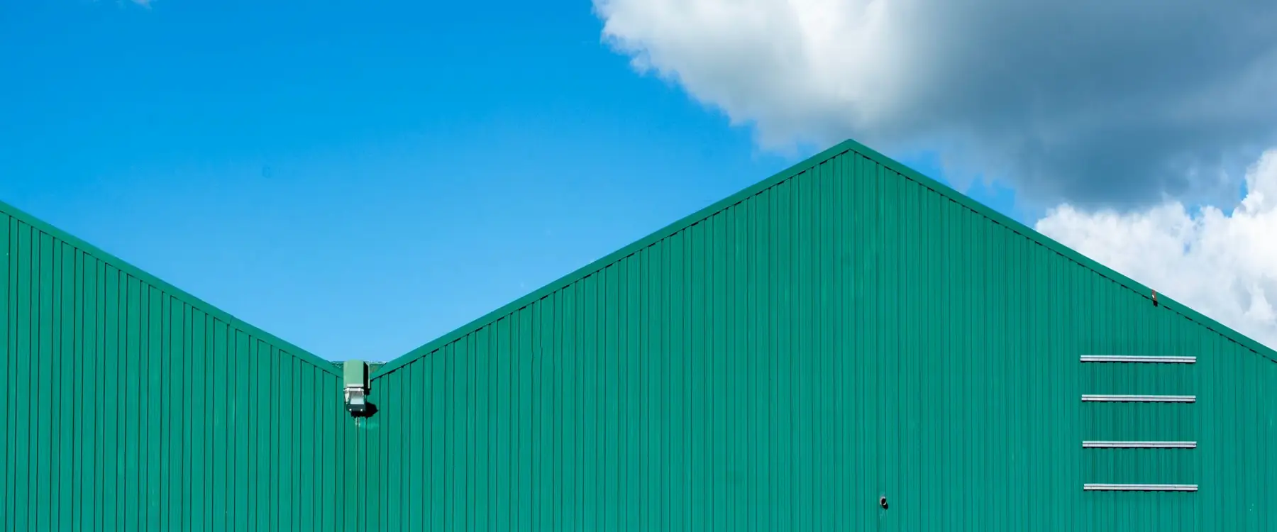 Steel-clad commercial building with twin gable roofs